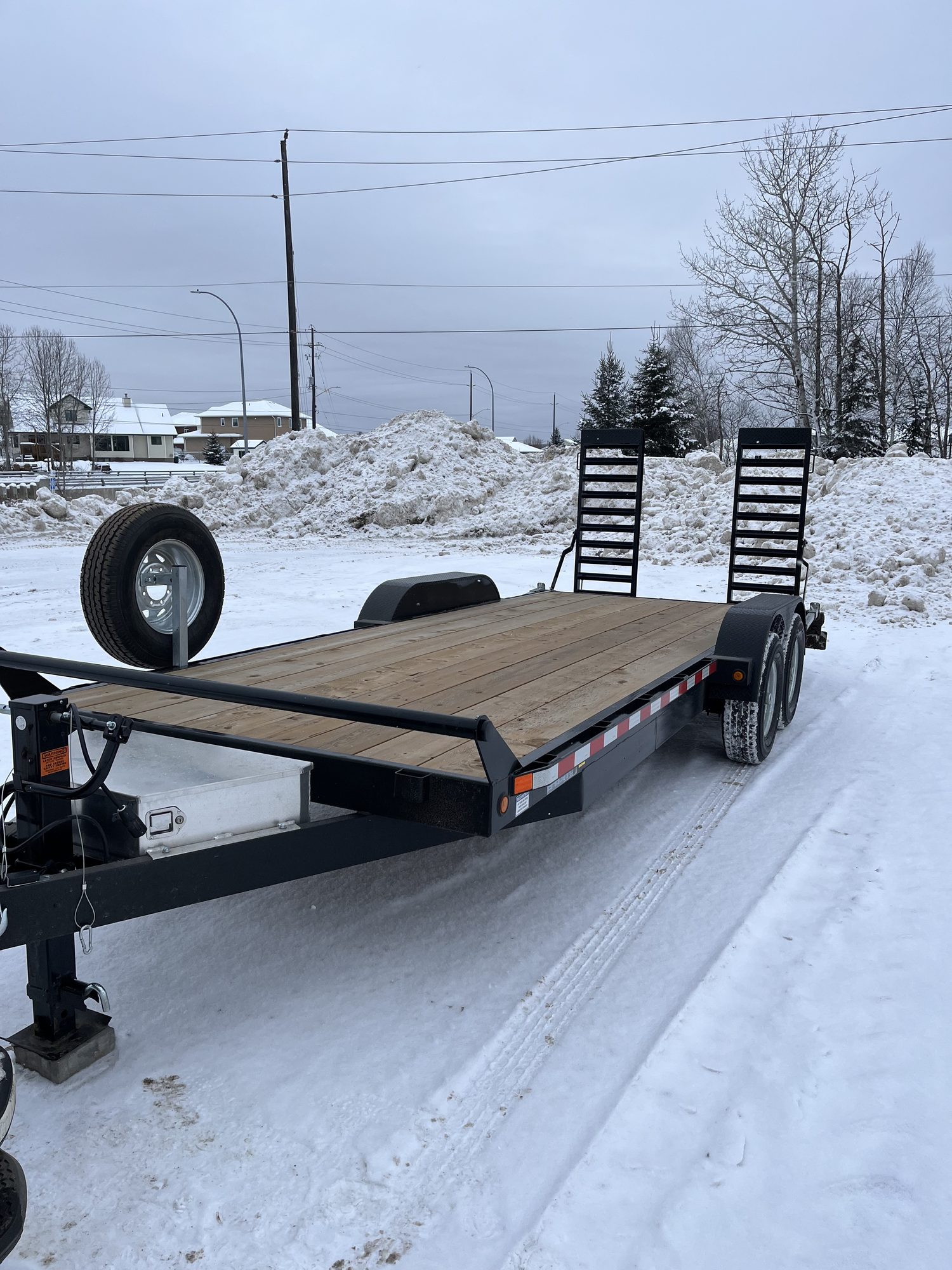 Equipment trailer on a snow covered northern road