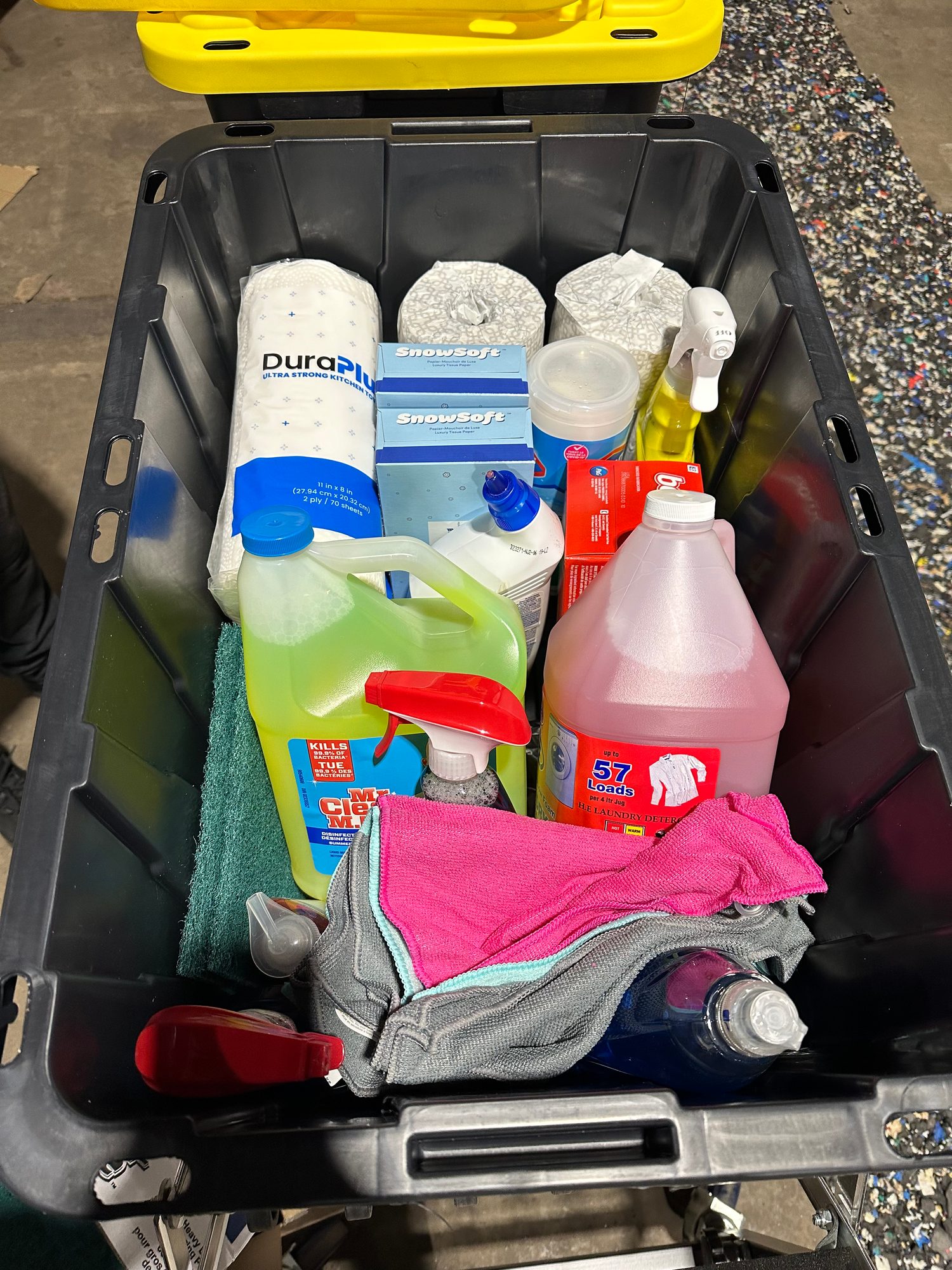 Tote of cleaning and household supplies packed for delivery